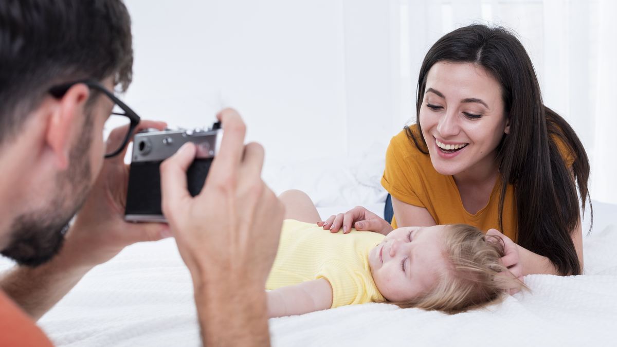 Mother looking through photo memories of baby and children on smartphone