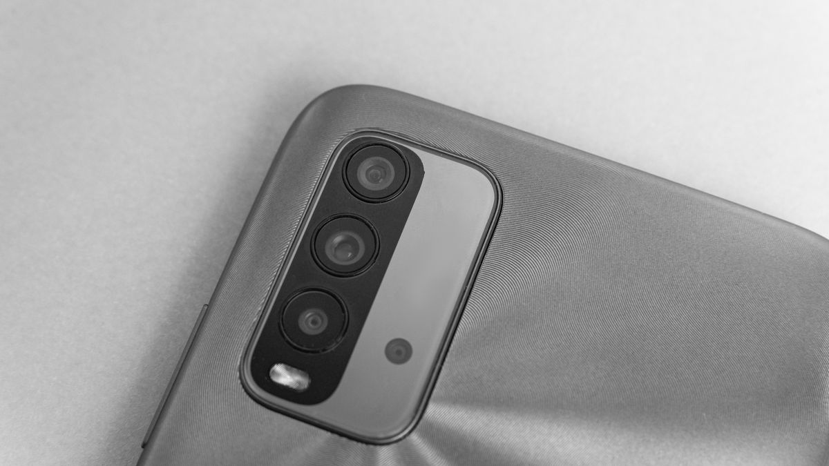 Close up of iPhone 16 Camera Control button on edge of titanium smartphone chassis