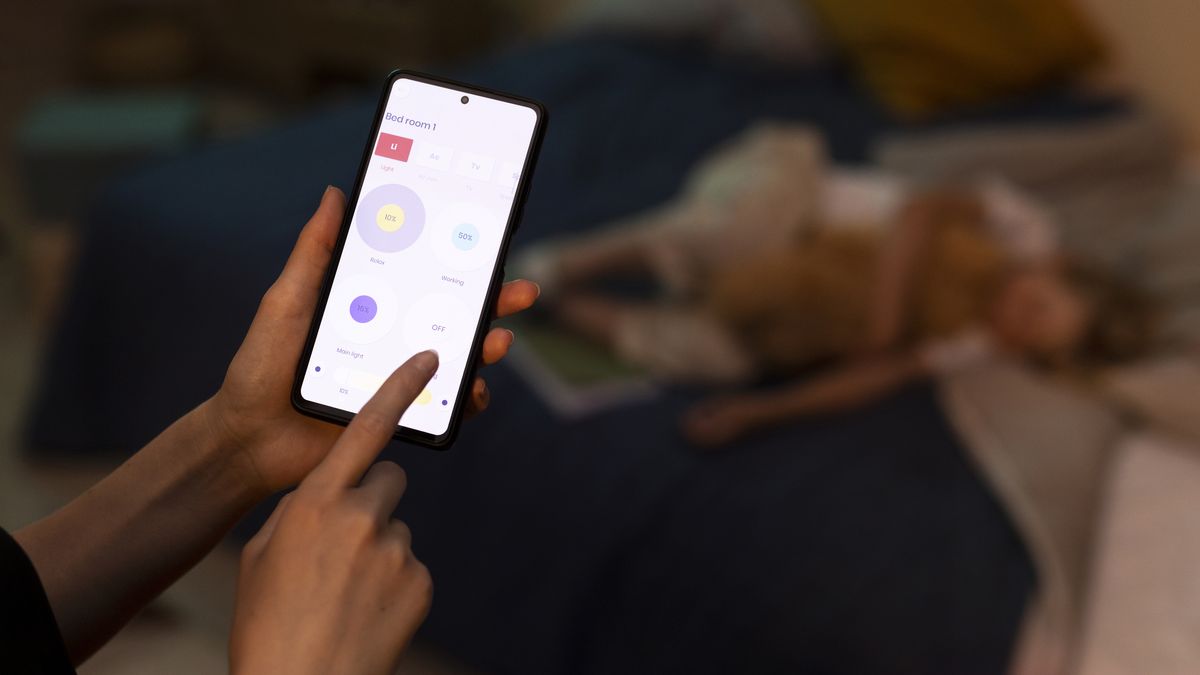 Overhead view of hands holding smartphone swiping through photo collection
